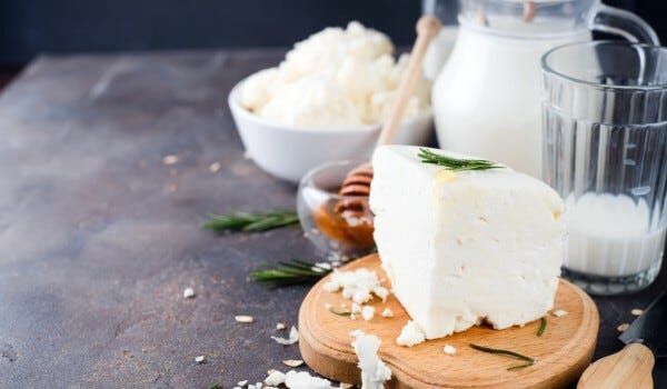 Ricotta cheese and milk on table