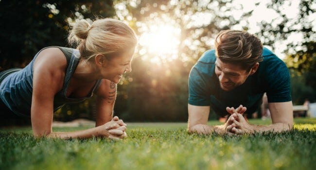 Two people exercising in a park