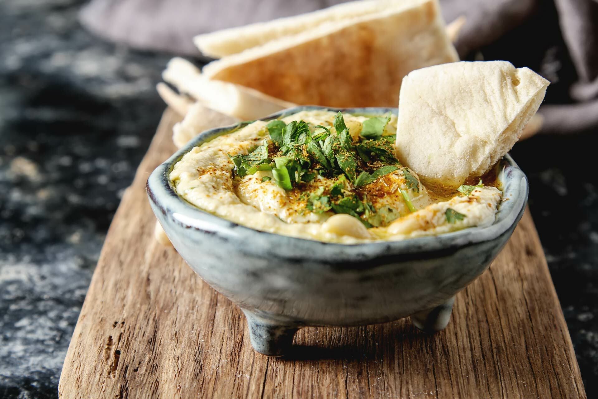 Hummus in bowl with flat bread - recipe