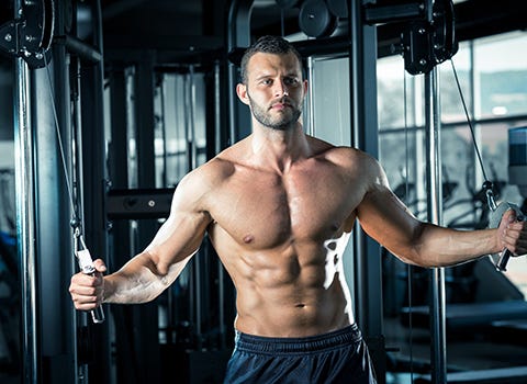 Shirtless man exercising in a gym