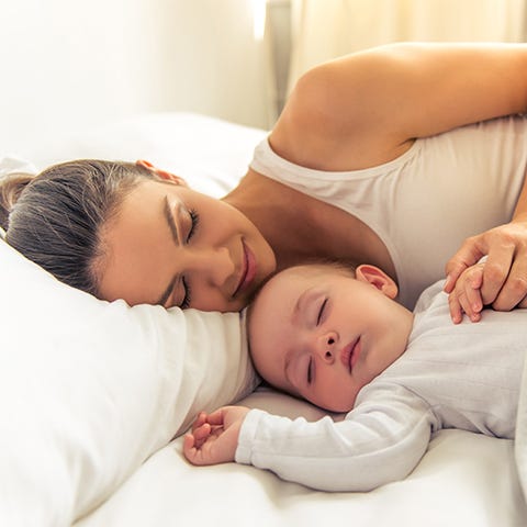 Mother on a bed with her baby