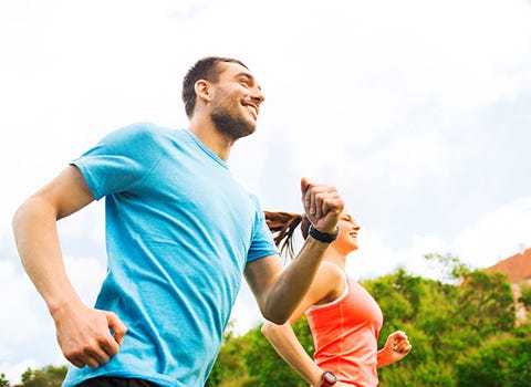 Man and woman running outdoors