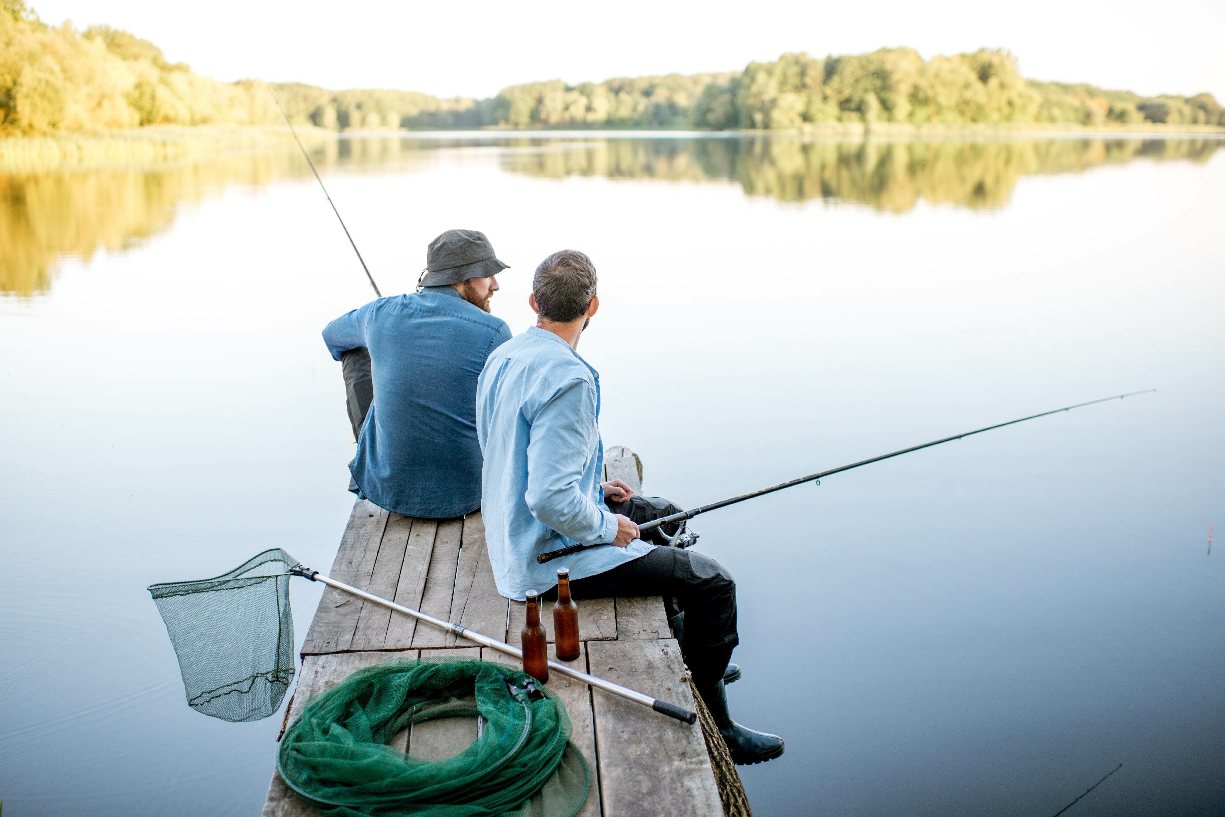 Two men fishing off a jetty