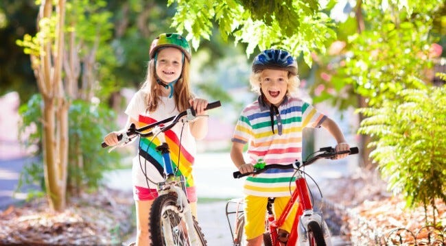 Two kids riding bicycles