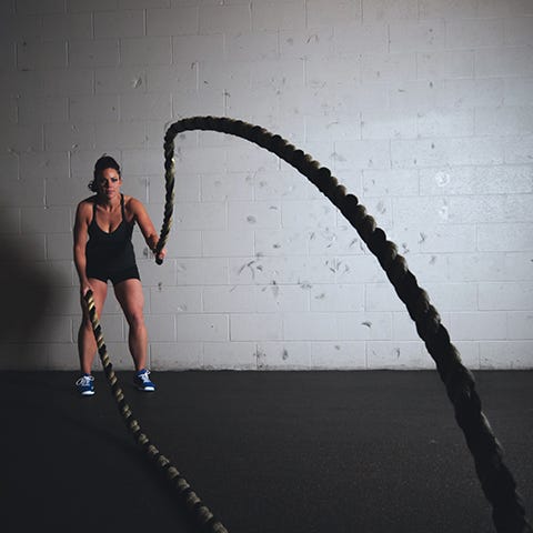 Woman training with ropes